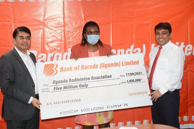 Managing Director R.K. Meena and Executive Director Mr. P.S. Bhati present a cheque to Ms Annet Nakamya.